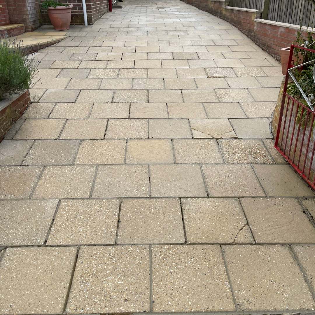 Clean paved driveway after pressure washing